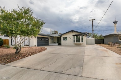 Single story home with driveway, an attached garage, and stucco siding