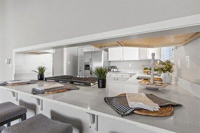 Kitchen featuring stainless steel fridge, white ca