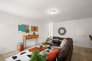 Living room featuring tile patterned floors and b