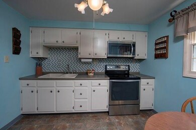 The glass backsplash and the stainless steel appli