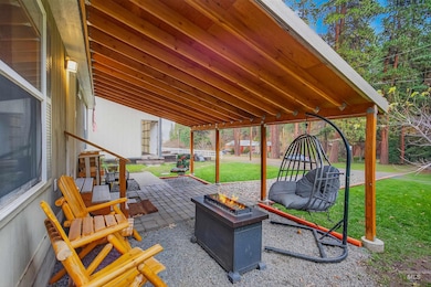 View of patio with an outdoor fire pit
