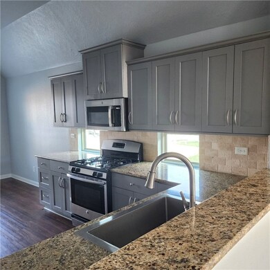 Kitchen featuring stainless steel appliances, gray