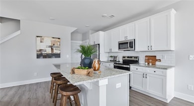 Kitchen featuring stainless steel appliances, ligh