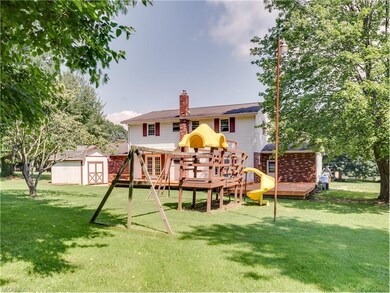 The back yard showcases a large play set that woul