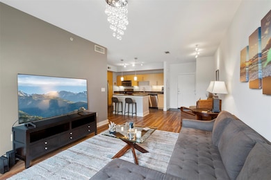 Living area featuring an inviting chandelier, visi