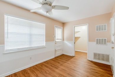 Unfurnished room featuring light wood-type floori