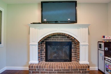 New custom mantle surrounds the fireplace to give it a fresh, updated look... and the TV stays!