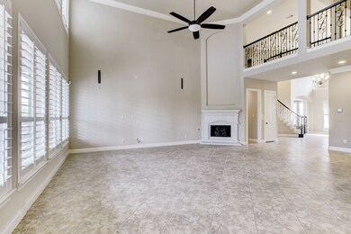 This large family room is perfect for entertaining guests! The two levels of wall-to-wall windows offers wonderful natural light.