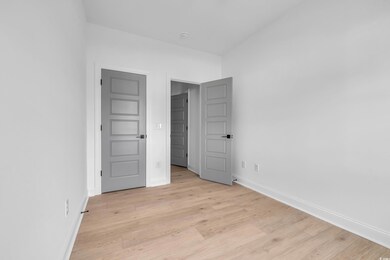 Unfurnished bedroom featuring light wood-style flooring