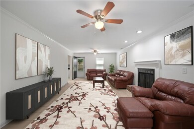***VIRTUALLY STATGED***Living room with light tile patterned flooring, ornamental molding, a fireplace, a ceiling fan, and recessed lighting