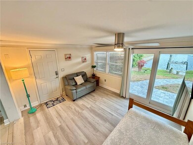 Living area featuring light wood finished floors, baseboards, ornamental molding, and a ceiling fan