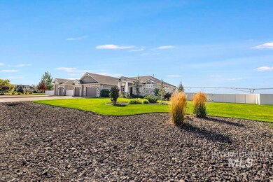 View of grassy yard with an attached garage and decorative driveway