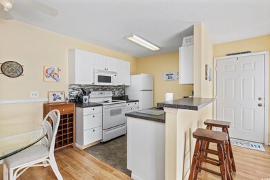 Kitchen featuring a breakfast bar, white cabinets,