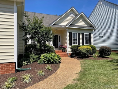 View of front of property with a front yard, roof