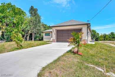 View of front facade with a front yard, a garage,
