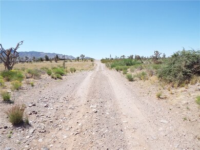 View of dirt / gravel road with a rural view and a