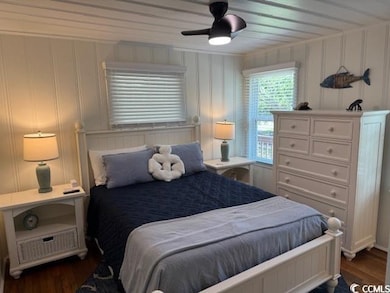 Bedroom with dark wood-type flooring and ceiling fan