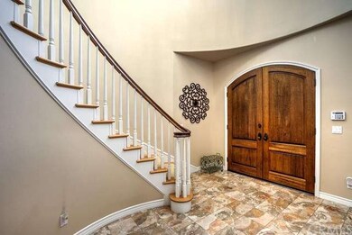 Custom wood doors open to a magnificent, spacious 