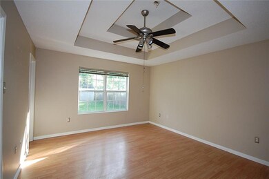 Master Bedroom with stepped ceiling, laminate floo