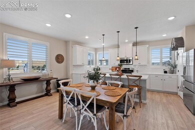 Dining space with a healthy amount of sunlight and light hardwood / wood-style floors