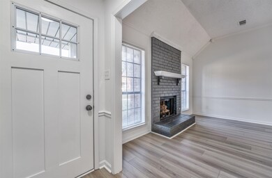 Foyer entrance with a fireplace, crown molding, va