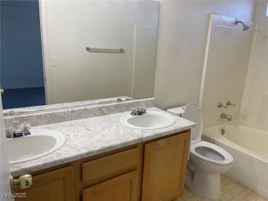 Full bath with double vanity, toilet, and bathing