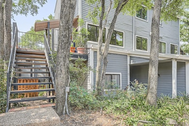 View of side of home featuring stairway
