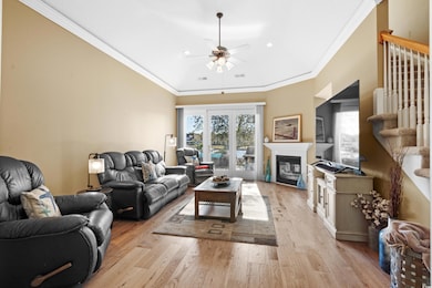 Living room with ceiling fan, light hardwood / woo