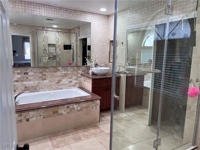 Bathroom featuring vanity, a garden tub, a shower