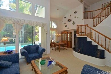 Large living room with views of the backyard opens