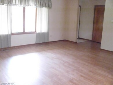 The living room floor is a wood-like laminate.