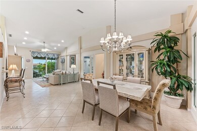 Dining space with light tile patterned floors, a chandelier, recessed lighting, ceiling fan, and high vaulted ceiling