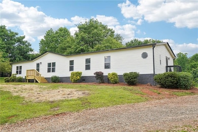 Rear view of property with crawl space and a lawn