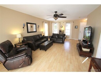 Spacious family room features laminate floors with