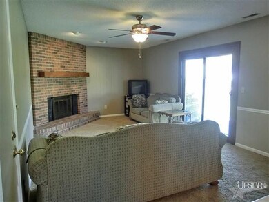 Family room with floor to ceiling brick fireplace,