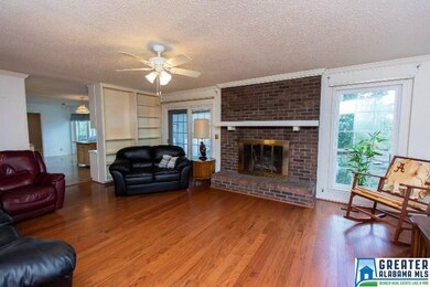 Cozy fireplace and gleaming hardwoods make for a c