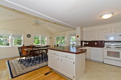 Kitchen and dining area with vaulted...