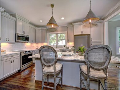 Gorgeous open kitchen with marble countertops, ove