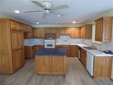 Spacious Kitchen with Wood Tile Floors and Center Island