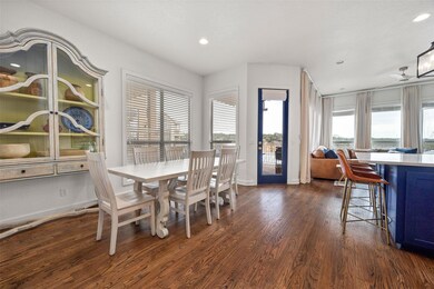 Dining area with dark wood-style floors, recessed 