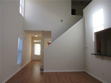 Entrance foyer featuring dark wood-style flooring and a high ceiling