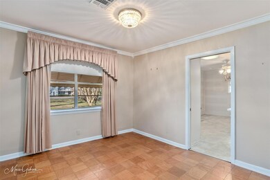Spare room with crown molding and light parquet fl
