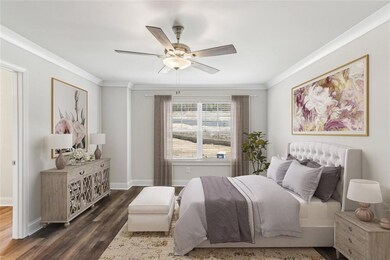 Bedroom featuring ornamental molding, dark hardwoo