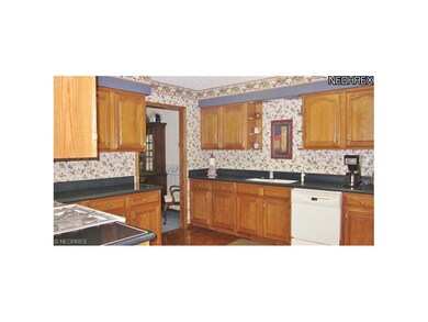Spotless Kitchen with hardwood floors and oak cabi