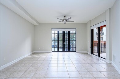 Empty room featuring ceiling fan, light tile patte