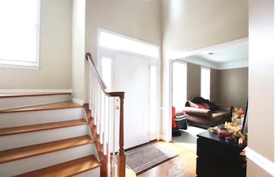 Foyer featuring light wood-type flooring and stairs