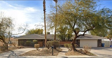 Single story home featuring fence, an attached gar