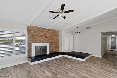 Unfurnished living room featuring wood finished fl