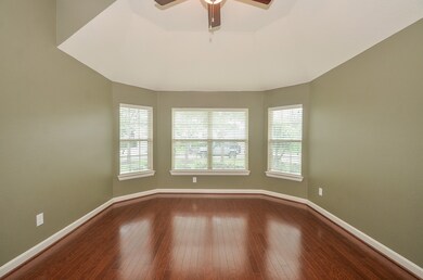 This exceptional study space is handsomely appointed with custom wall paint, high ceilings with fan, spotless flooring, and tons of room for an office or a secondary living area.