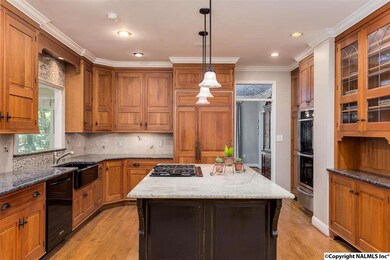 Double Ovens, Warming Drawer, 4 Eye Gas Range, Wood Floors, and Kitchen Island.